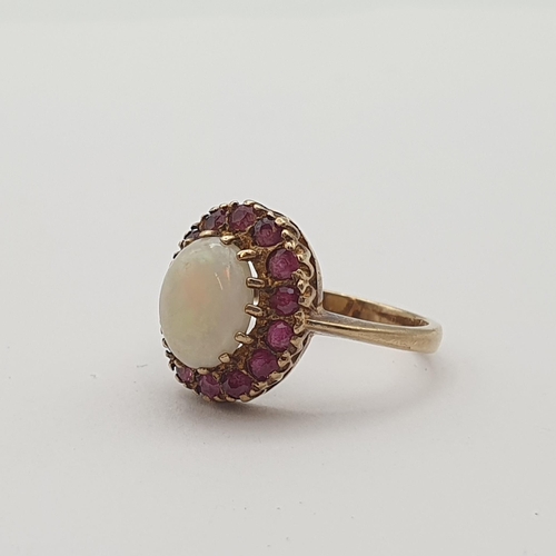 168 - An Opal and Ruby Cluster Ring claw-set oval opal cabochon within frame of round rubies in 9ct gold, ... 