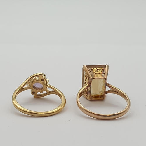 174 - A Citrine Dress Ring claw-set emerald-cut stone in 14ct gold (ring size P1/2, 5gms) and a yellow met... 