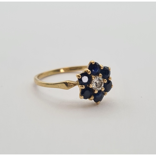 176 - A Diamond and Sapphire flower Cluster Ring claw-set brilliant-cut diamond within six round sapphires... 