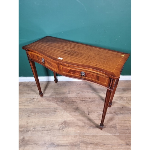 20 - A reproduction mahogany veneered serpentine fronted Side Table fitted two frieze drawers on square s... 