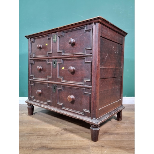 29 - An 18th Century and later oak Chest of three long drawers with geometric moulding raised on turned s... 