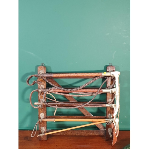 40 - An oak Whip Rack and four Whips (R9)