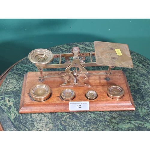 42 - A set of brass Postal Scales on mahogany plinth base. (R7).