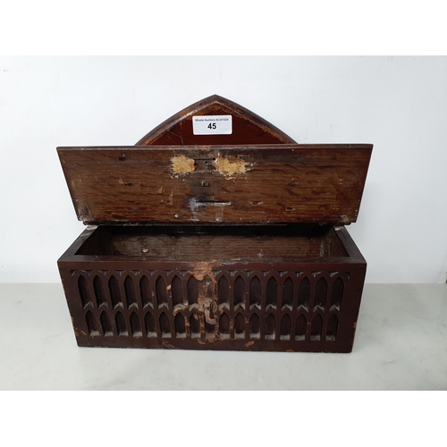 45 - An antique oak Offertory Box with arched top above hinged lid with iron strapwork hinges, two tier g... 