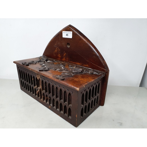 45 - An antique oak Offertory Box with arched top above hinged lid with iron strapwork hinges, two tier g... 