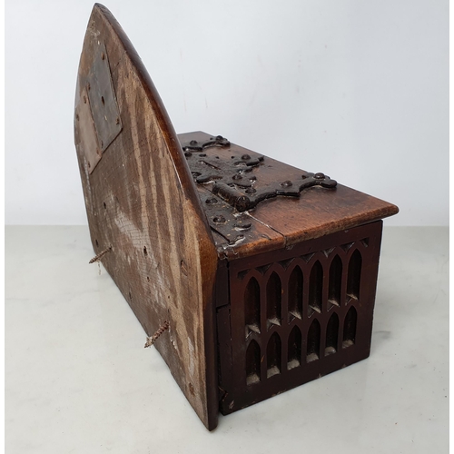 45 - An antique oak Offertory Box with arched top above hinged lid with iron strapwork hinges, two tier g... 