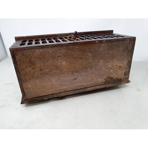 45 - An antique oak Offertory Box with arched top above hinged lid with iron strapwork hinges, two tier g... 