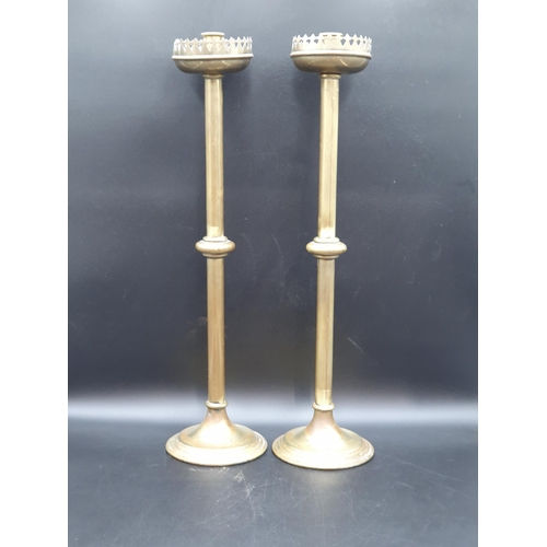 49 - A pair of tall brass Church Candlesticks with large pierced drip pans on single knop stems, 2ft (R1)