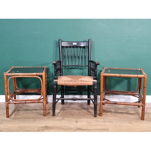 521 - An ebonised Elbow Chair with rush seat and a pair of bamboo glass topped Occasional Tables (R6)