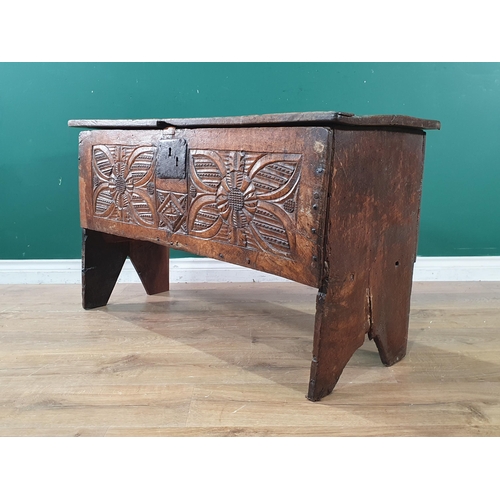 605 - A 17th Century and later oak six plank Chest with flower head carved front raised on V cut end suppo... 