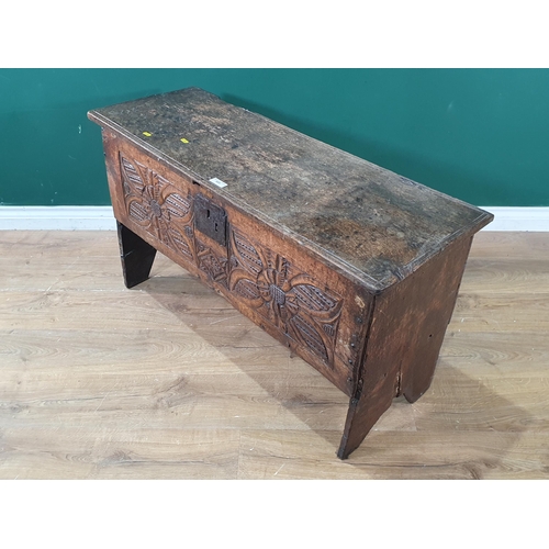 605 - A 17th Century and later oak six plank Chest with flower head carved front raised on V cut end suppo... 