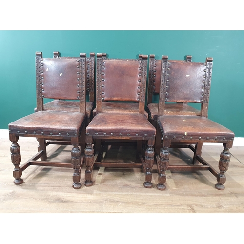 608 - A set of six carved oak framed Dining Chairs with brown leather effect upholstery, on carved leafage... 