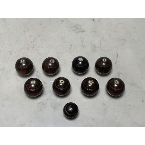 61 - A set of miniature flat or crown green Bowling Balls, turned hardwood with inset numbers, complete w... 