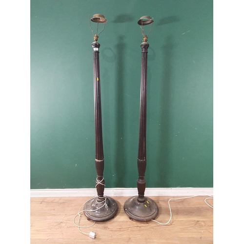 616 - A pair of antique mahogany Standard Lamps with fluted and leafage carved columns on circular bases (... 