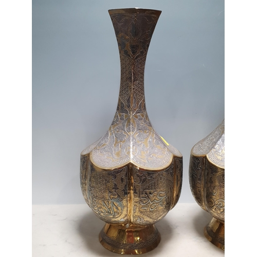 626 - A pair of Islamic brass and inlaid hexagonal Vases with engraved trailing leafage design 1ft 4in H (... 