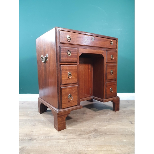 628 - A Georgian style mahogany Kneehole Desk fitted nine drawers flanking recessed cupboard door 2ft 6in ... 