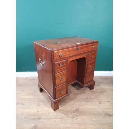 628 - A Georgian style mahogany Kneehole Desk fitted nine drawers flanking recessed cupboard door 2ft 6in ... 