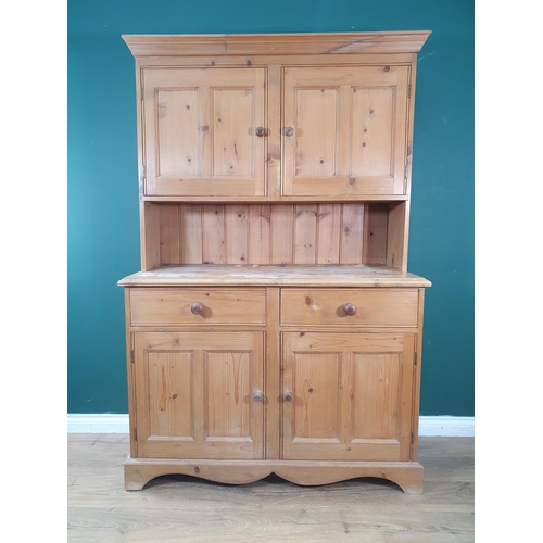 642 - A pine Kitchen Dresser, the top section with moulded cornice above pair of panelled doors, the base ... 