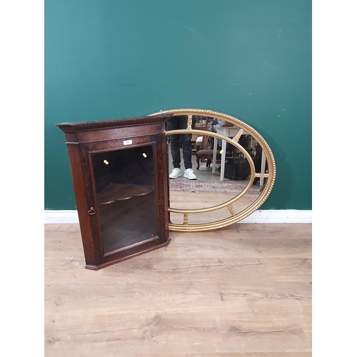 650 - An oak and glazed hanging Corner Cabinet 2ft 8in H x 2ft W and a gilt framed oval Wall Mirror 3ft 8i... 