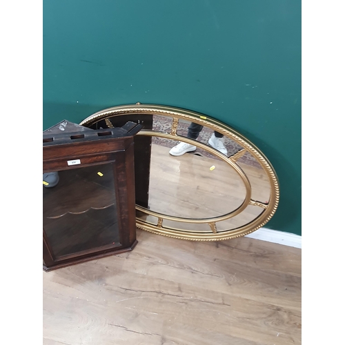 650 - An oak and glazed hanging Corner Cabinet 2ft 8in H x 2ft W and a gilt framed oval Wall Mirror 3ft 8i... 