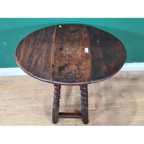 678 - An oak Dropleaf Table on bobbin turned supports united by stretchers, 2ft 1