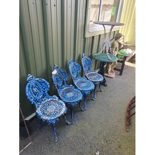 717 - A set of four cast iron Garden Seats with pierced and scrolled designs, later painted blue, and two ... 