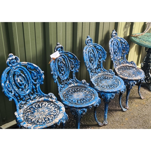 717 - A set of four cast iron Garden Seats with pierced and scrolled designs, later painted blue, and two ... 