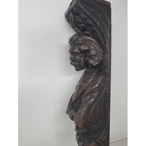 73 - An antique oak Caryatid depicting figure with folded arms, 17in (R6)