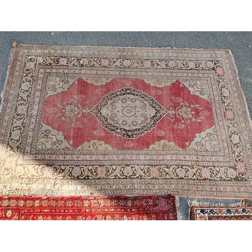 848 - A Persian style Rug with multiple borders with central medallion on a red ground, 5ft 9in x 3ft 11in... 