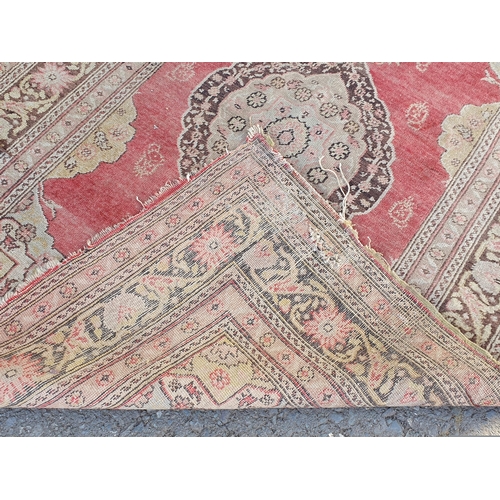 848 - A Persian style Rug with multiple borders with central medallion on a red ground, 5ft 9in x 3ft 11in... 