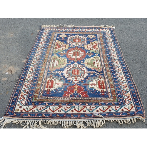 859 - A multi-bordered Persian Rug with multi-coloured stylised medallions upon a blue ground, 8ft 11in L ... 