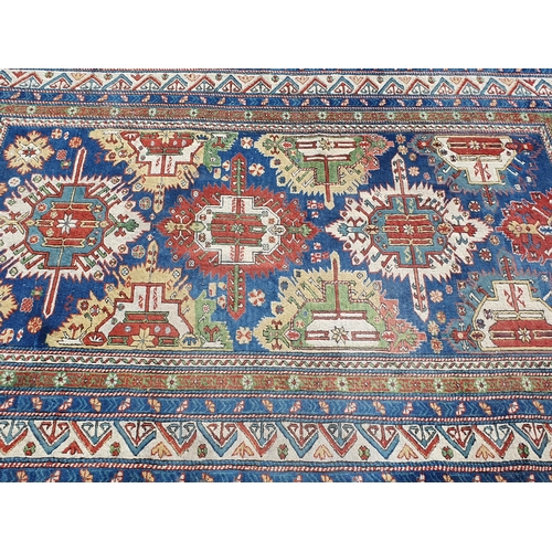 859 - A multi-bordered Persian Rug with multi-coloured stylised medallions upon a blue ground, 8ft 11in L ... 