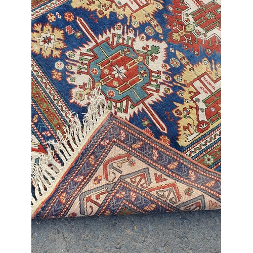 859 - A multi-bordered Persian Rug with multi-coloured stylised medallions upon a blue ground, 8ft 11in L ... 