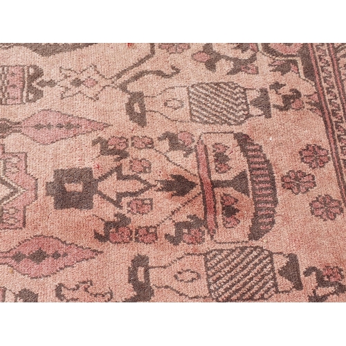 860 - A pale red multi-bordered Persian Rug with stylised design, depicting birds, 6ft 6in L x 4ft W