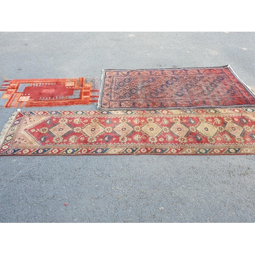 867 - A Runner on red ground with multi-floral borders with seven central stylised medallions, 10ft L x 2f... 