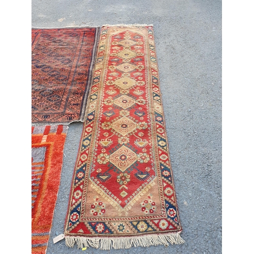 867 - A Runner on red ground with multi-floral borders with seven central stylised medallions, 10ft L x 2f... 