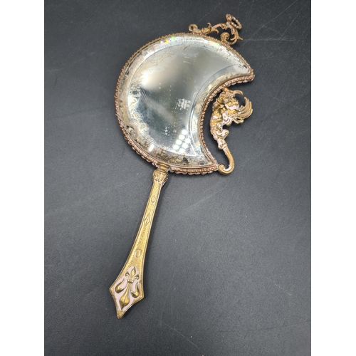 95 - A French Art Nouveau miniature Hand Mirror of crescent shape painted young lady, paste surround, che... 