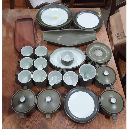 334 - A green and cream Denby part Service including, Milk Jug, Cups and Saucers, lidded Containers, Dinne... 