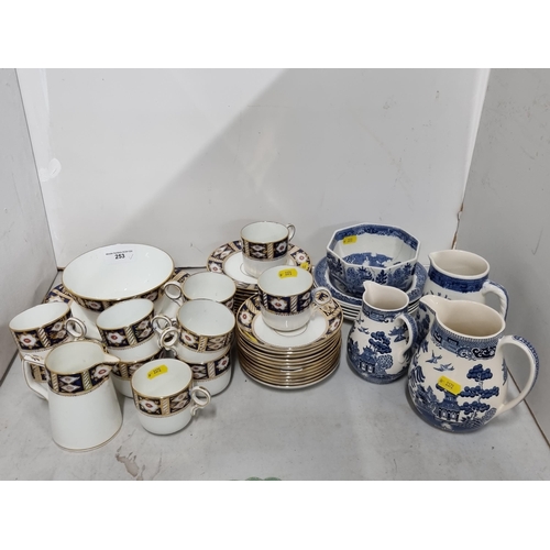 253 - An Imari style part Tea Service including Coffee Cans, Saucers, Milk Jug, and a Wedgewood Willow pat... 