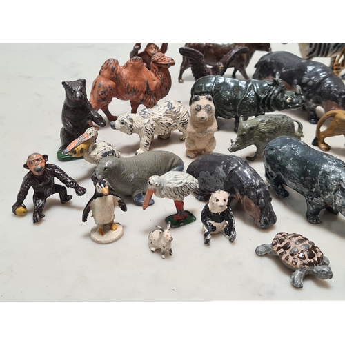 12 - A Collection of approximately 40 cast metal Zoo Animals to include, a Giraffe, Hippo, Lion, Sea Lion... 