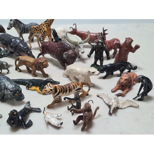 12 - A Collection of approximately 40 cast metal Zoo Animals to include, a Giraffe, Hippo, Lion, Sea Lion... 