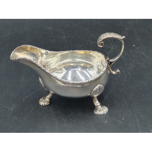 22 - A George III silver Sauce Boat with gadroon rims on scallop feet, London 1766