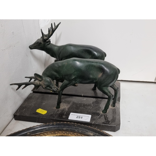 251 - A pair of cast metal Stags mounted on rectangular marble plinths, and a pair of antique oval framed ... 