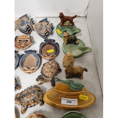 258 - A collection of Wade to include, small Fish Dishes, Tortoise Boxes, three Wade Pipe Holders, a Wade ... 