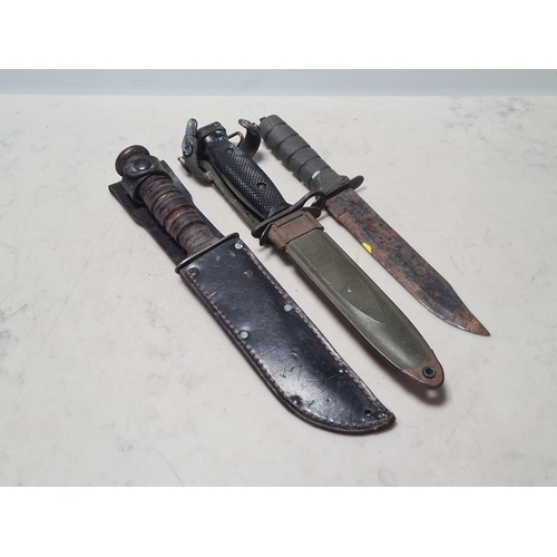 26 - A US M8A1 Bayonet with scabbard, a US Camillus Survival Knife with scabbard and another Knife (All A... 