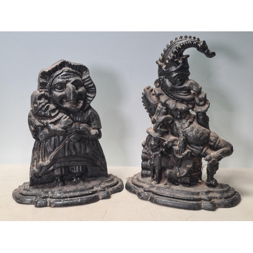 28 - A pair of cast iron Punch and Judy Doorstops and a Hand Bell with turned wooden handle, handle A/F. ... 