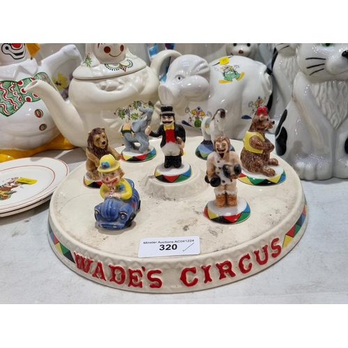 320 - Collectables to include, a Wade's Circus Stand with Figures, five Wade Cat Money Boxes, a Wade Piggy... 