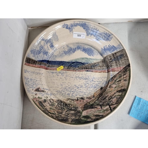 323 - A large pottery Bowl decorated with scene of Loch Tay, made by the Artist Paul Thomas of Leonard Sta... 