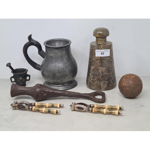 62 - An old iron Canon Ball, an early iron Bell Clapper, small bronze Mortar and Pestle, two pairs of Nut... 