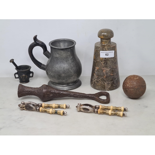 62 - An old iron Canon Ball, an early iron Bell Clapper, small bronze Mortar and Pestle, two pairs of Nut... 